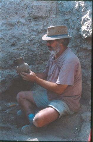 Dr. Downing with a pot he found on a dig.