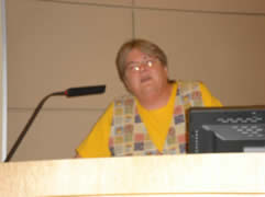 A woman speaking at a podium.