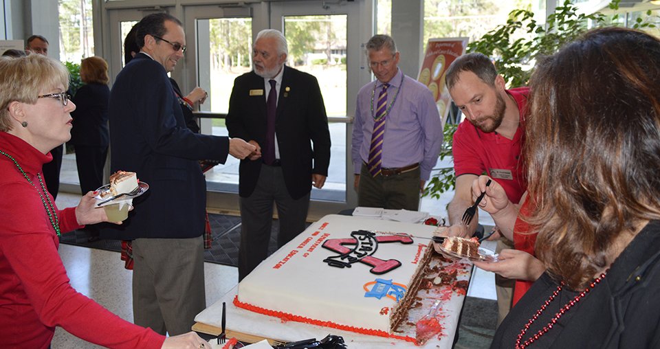 Mr. Corey Nawolski hands out anniversary cake