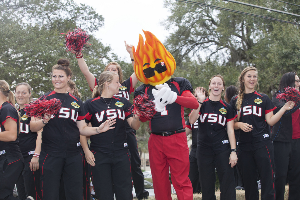 Members of the softball team ride on a parade float with VSU mascot