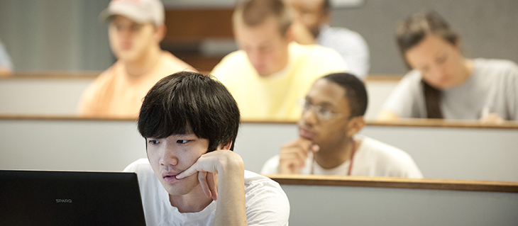 Students sitting in class in front of computers