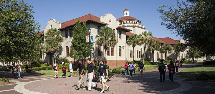 Photo of West Hall with students walking by.