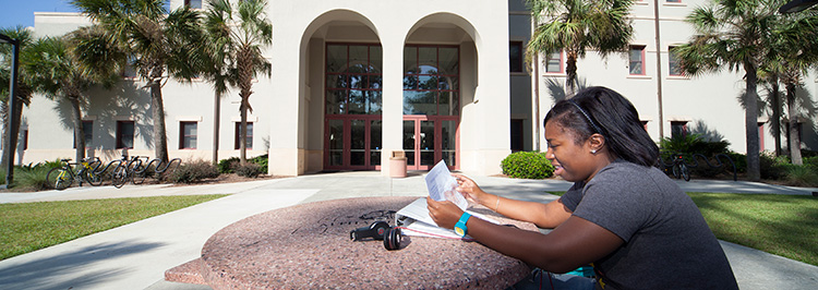 Student studying outside building