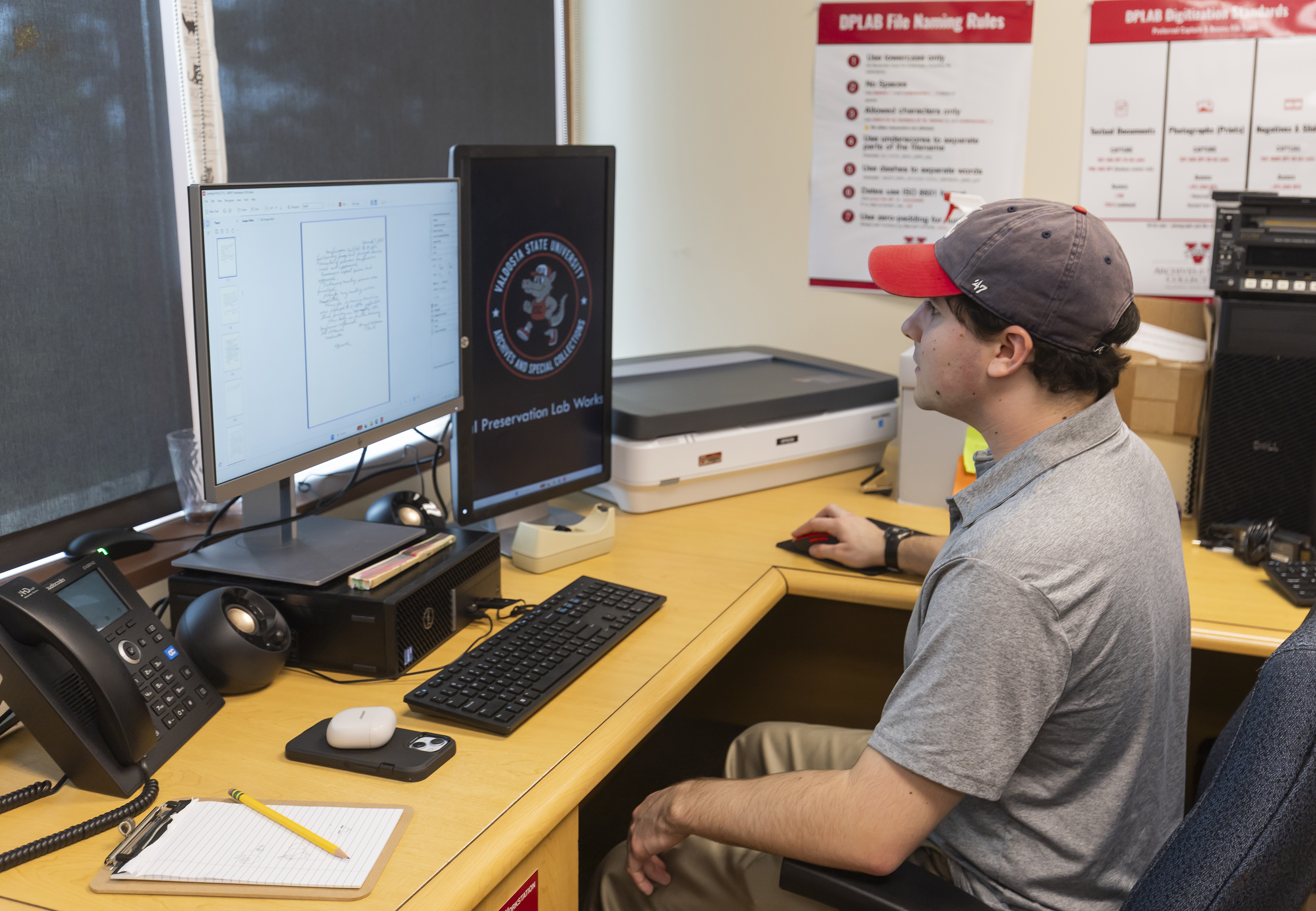 student at computer scanning in historical documents
