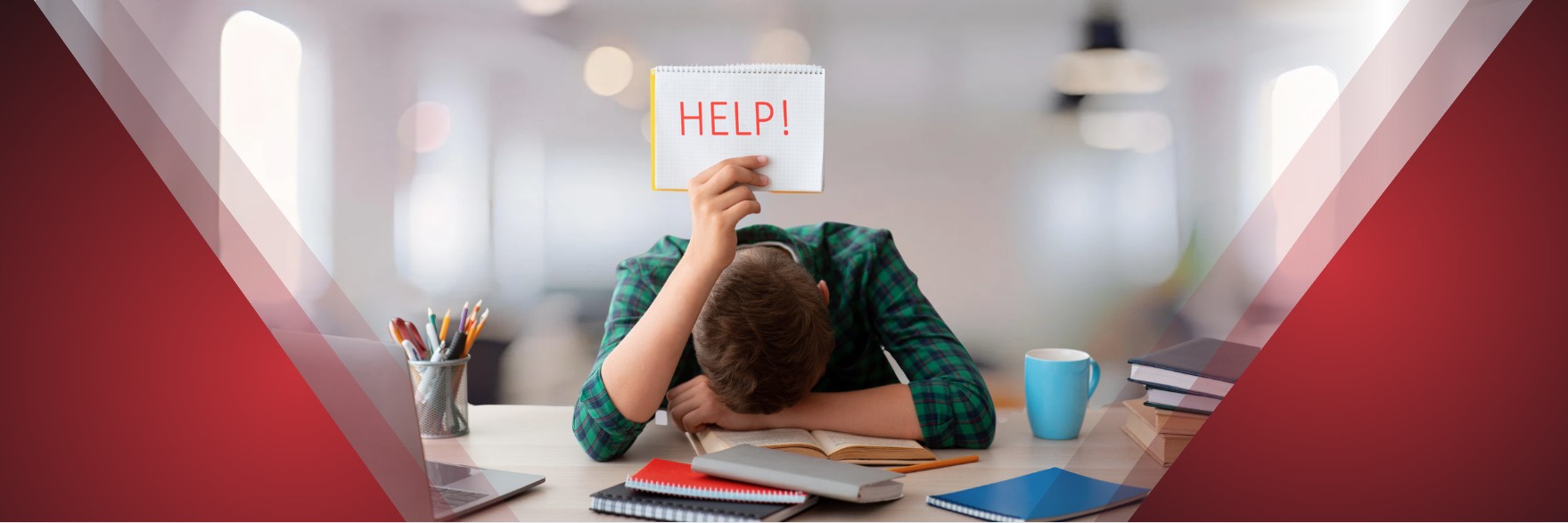Student slumped over an open book at a desk, holding a notepad that says “HELP!” above their head.