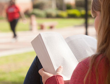 Student reads book on VSU campus