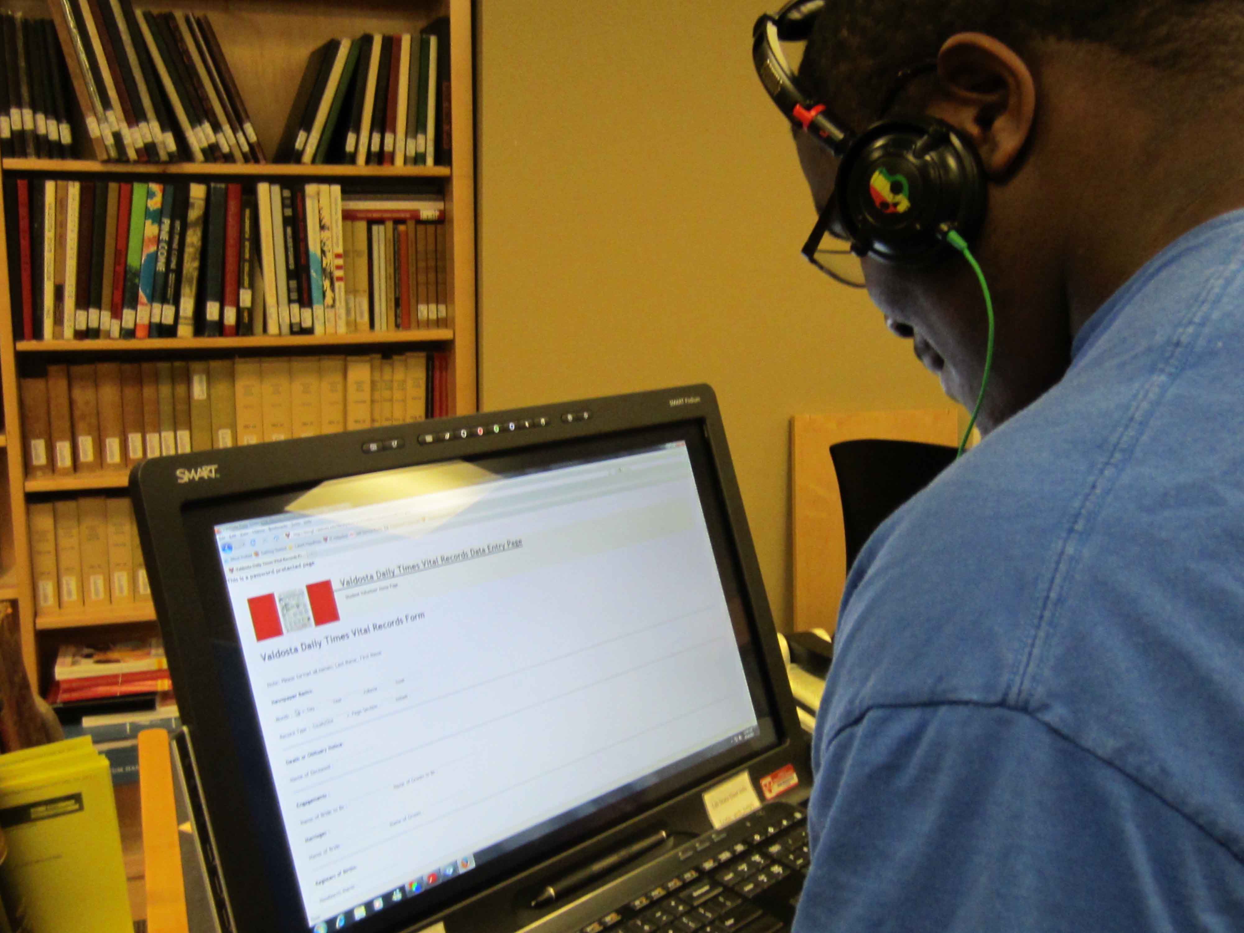 A student volunteer works on a computer