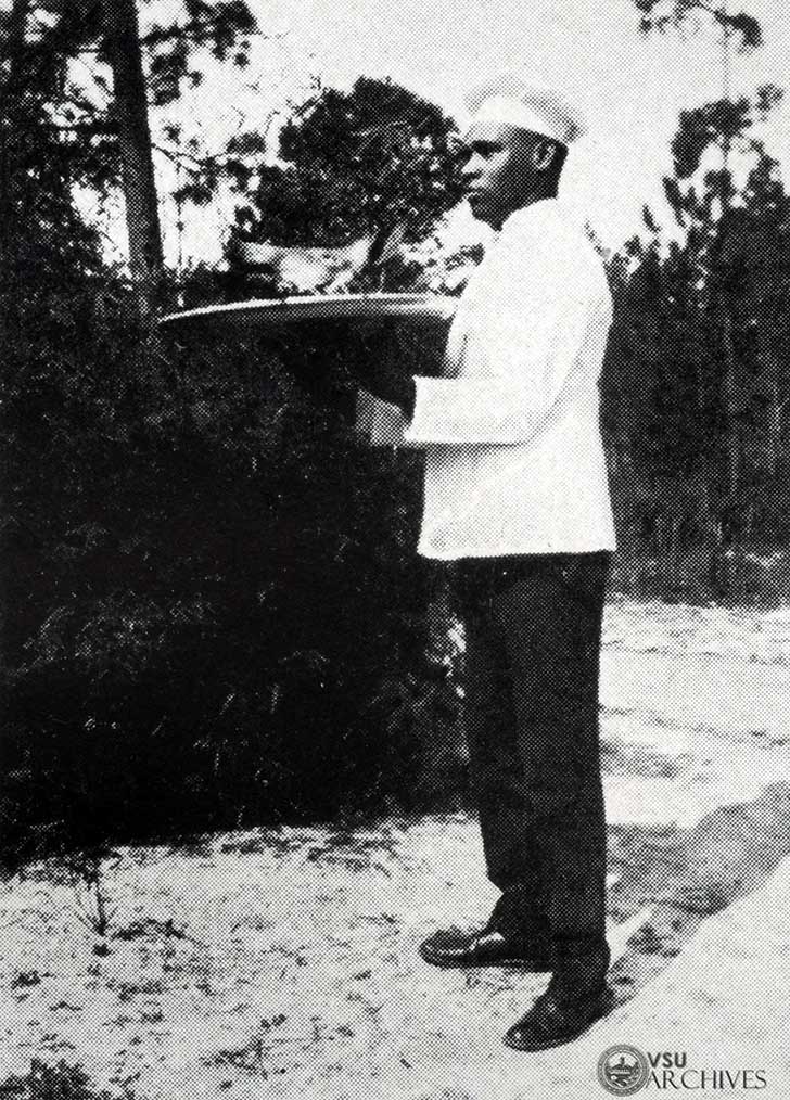 GSWC Cook Serving Boars Head for the Old English Christmas Feast, 1924