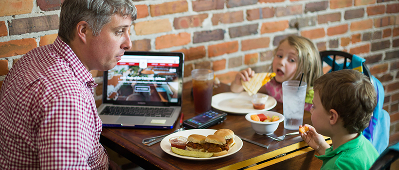 Dad studying with kids in restaurant