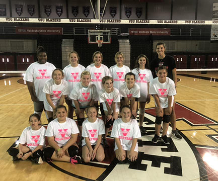 VSU volleyball team gathered on court