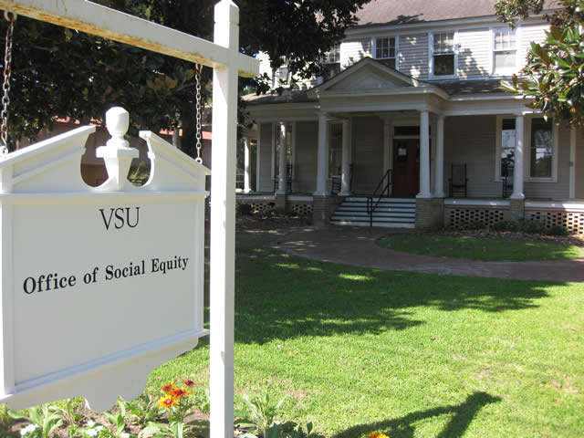 A white sign outside of the Social Equity Office.