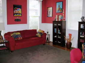 A Room with a sofa and several bookcases.