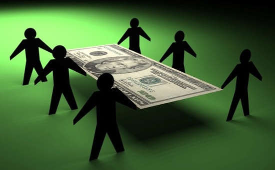 Silhouetted people holding a $20 bill