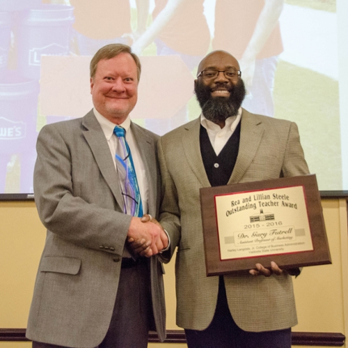 Dr. Gary Futrell receiving his award.