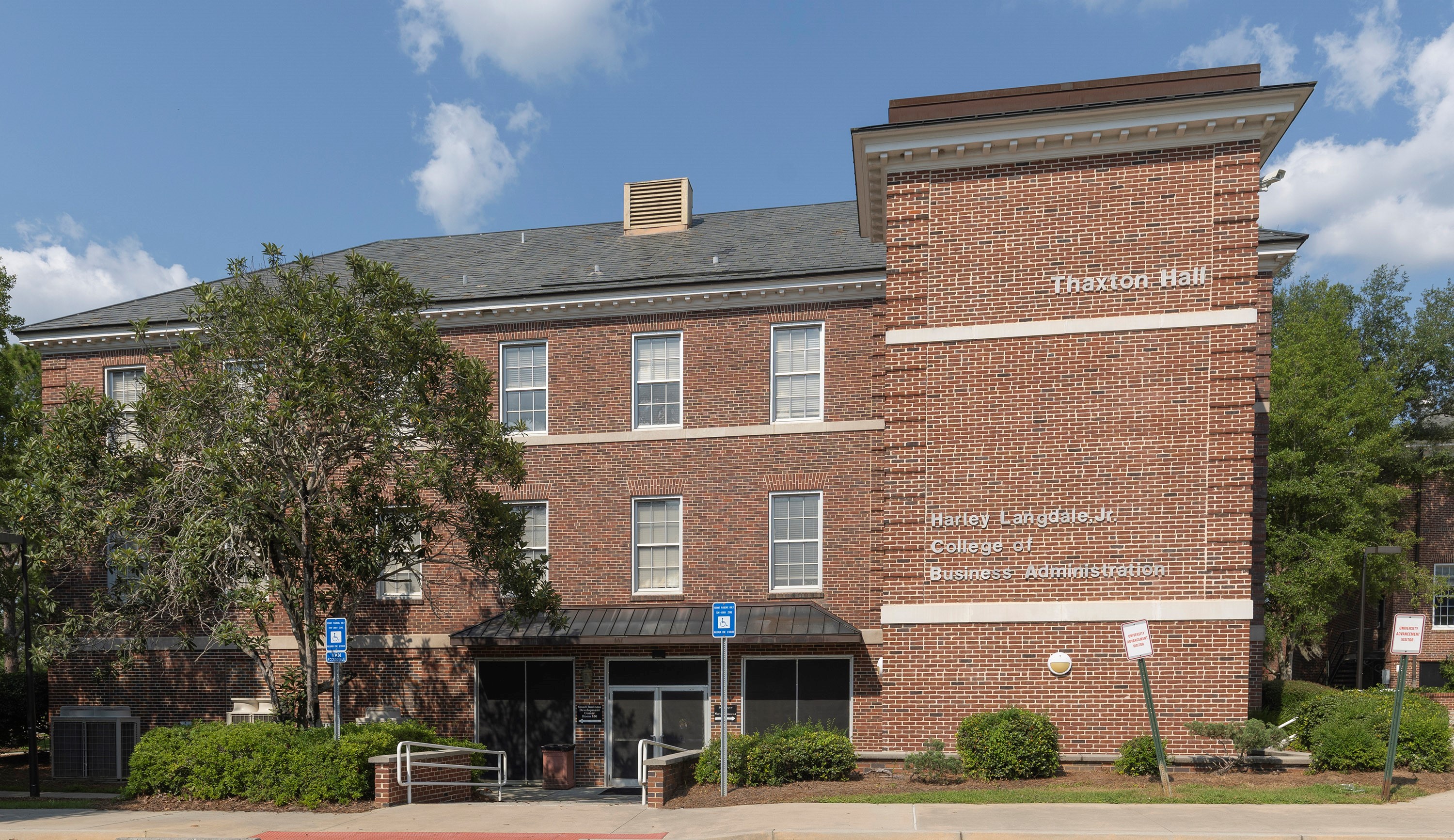 Exterior of a red-brick campus building labeled "Thaxton Hall" and "Harley Langdale Jr. College of Business Administration.