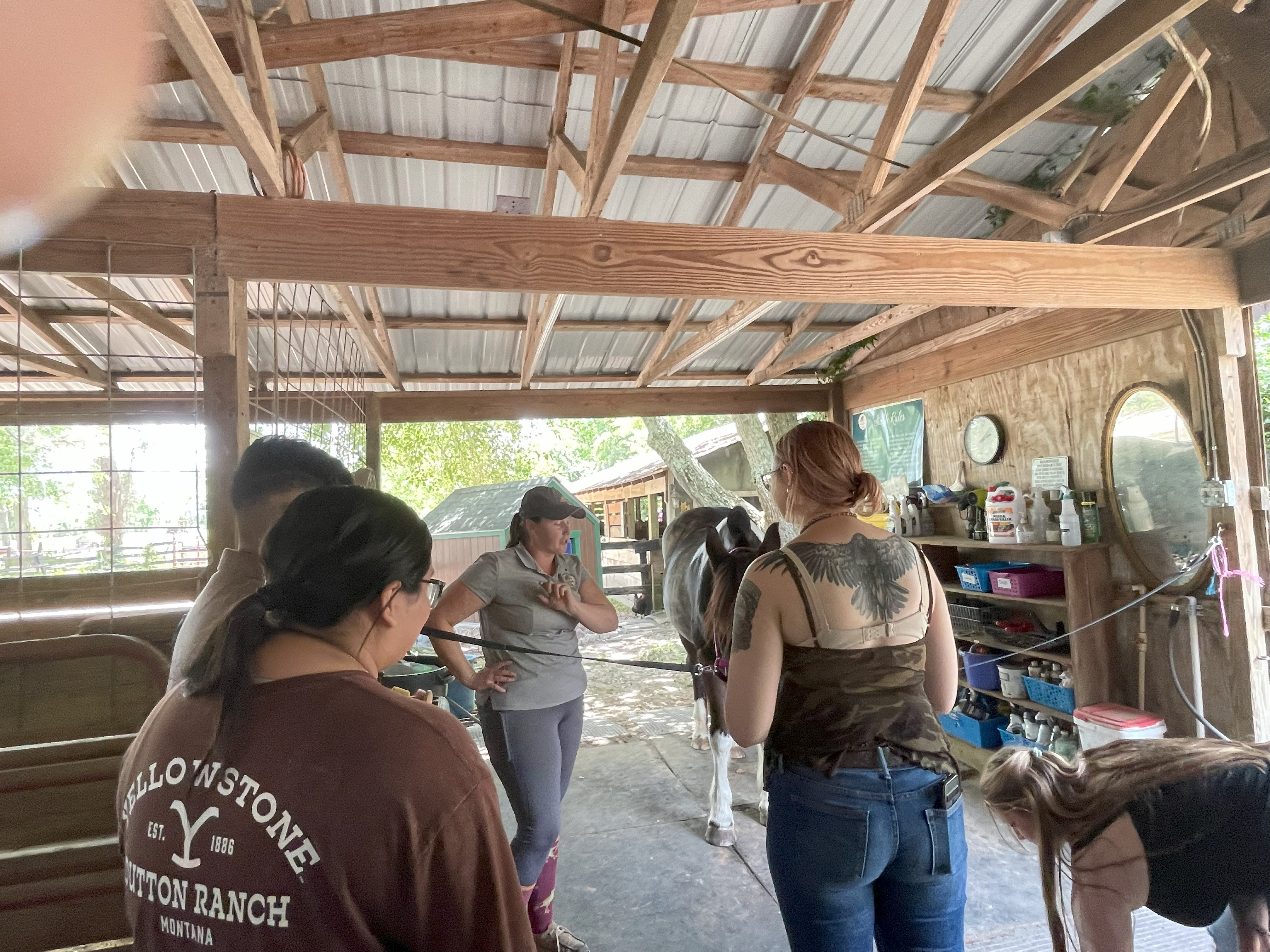 students-barn-aisle-listening-to-a-lady.jpg